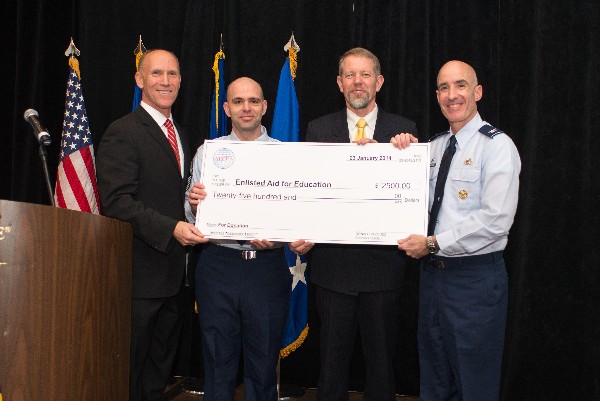 In January, Bud Vazquez (l), chapter president, and Scott Hardiman (2nd from r), board chairman, present a $2,500 check to Col. Lester Weilacher, USAF (r), base commander, and Chief Master Sgt. Gerald Nunes, USAF, for the air Force Enlisted Education Fund.