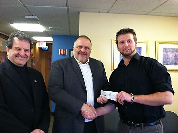 Jay Kanavos (c), chairman, Science Teaching Tools Committee, presents a $2,000 grant to Chris Brandes (r), a biology teacher at the Advanced Math and Science Academy (AMSA), as John Brucato, executive director, AMSA, looks on.