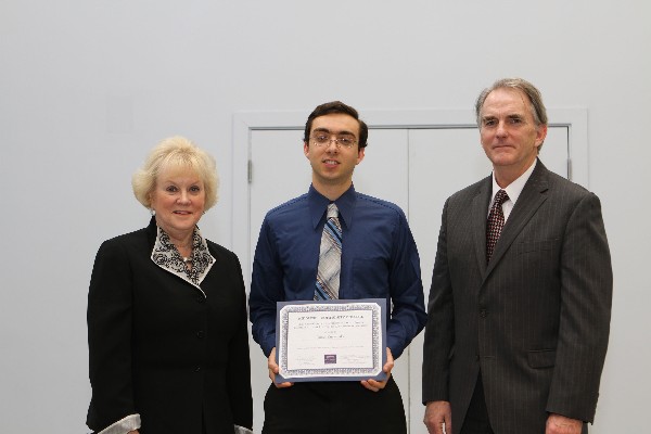 In March, Middlesex Community College student James Kuczynski (c) of North Billerica receives a chapter scholarship from Cowan and Linnehan.