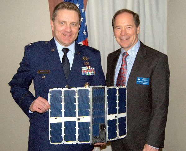 Col. Scott W. Beidleman, USAF (l), director, development, planning, Space and Missile Systems, Los Angeles Air Force Base, California, joins Spencer Bower, chapter president, and full-scale model of a SENSE Cubesat in January.