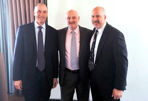 Speaking at the March meeting is Dave W. Madden (c), executive director, Space and Missile Systems Center, Los Angeles Air Force Base, with Bill Page (l), chapter vice president, programs, and Adam Feingold, chapter president.