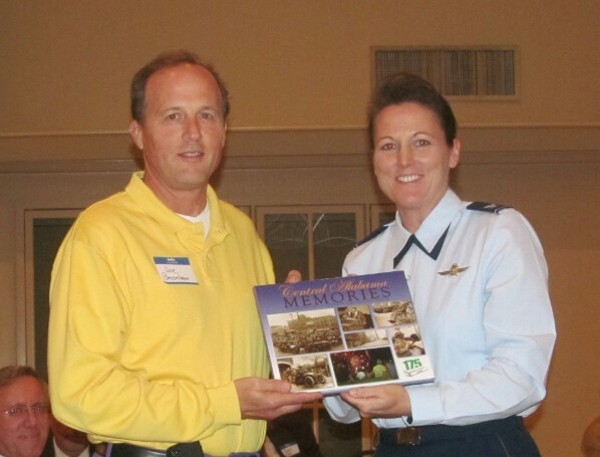 Dr. Joseph Besselman, chapter president, presents a welcoming gift to Col. Tammy M. Knierim, USAF, director education operations and information, headquarters, Air University, Maxwell Air Force Base, at the October meeting.