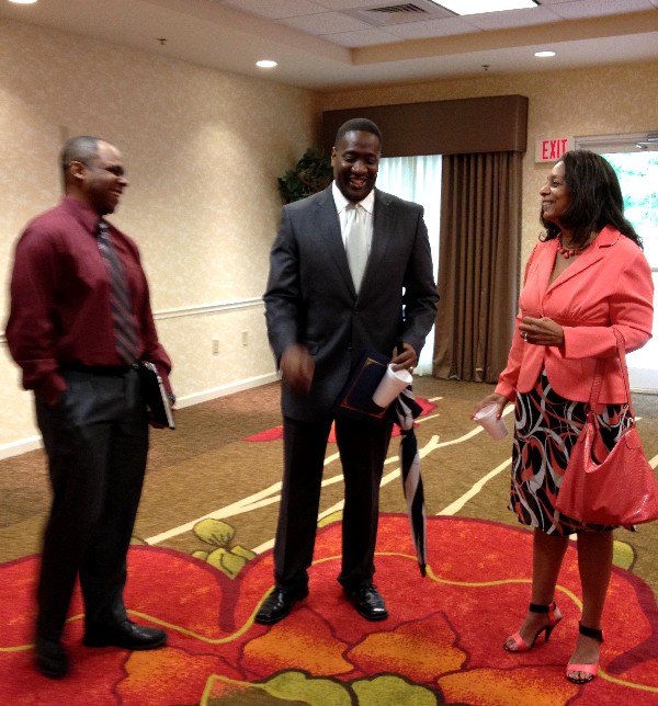 Business Over Breakfast attendees network with Bush (c) after the presentation in May.