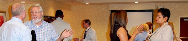 Guests network after the August Business Over Breakfast event.