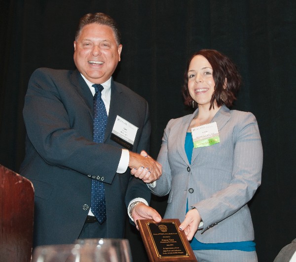Sam Jones, chapter president, recognizes Alexa Tsui, sales and account manager at Bloomberg Government, as the June Young AFCEAN Award recipient.