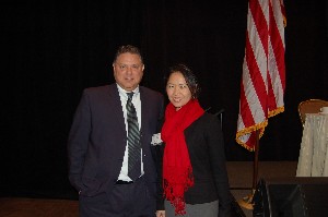Sam Jones, chapter president, presents the chapter's December SuperNOVA Award to Connie Zhong, director of federal healthcare solutions for the Capital Region at Emergint Technologies.