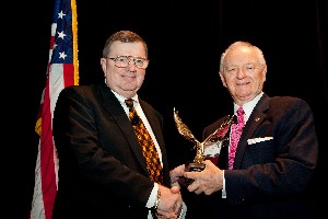 At the 4th Annual Warfighter Support IT Day in August, Chuck Corjay (r), former chapter president, presents a token of appreciation to Dr. Ronald Jost, deputy assistant secretary of defense for command, control, communications, space and spectrum.