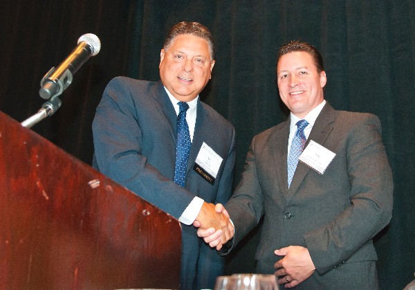 In June, Jones (l) presents Greg Kipper, consulting futurist for General Dynamics AIS, with the SuperNOVA Award.