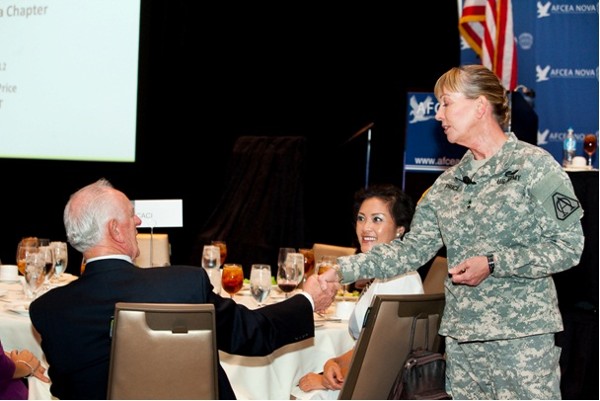 In October, Gen. Price presents Chuck Corjay with a coin.