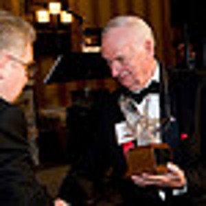 Master of Ceremony Chuck Corjay (r) receives a Lifetime Achievement Award from Harry Picarrello, chapter president, at the February event. Corjay was recognized for his exceptional performance in support of the chapter.