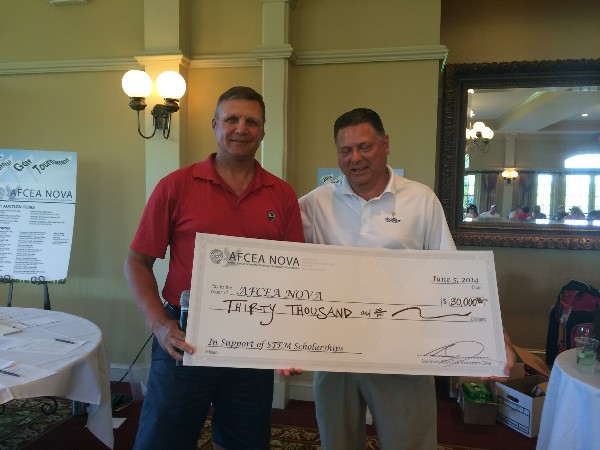 Sam Jones (r), golf tournament chair, presents a check to Ron Zich, chapter president, in June.