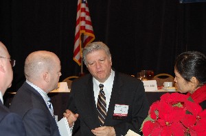Tony Montemarano, Senior Executive Service, Defense Information Systems Agency, visits with attendees at the December meeting following his speech.