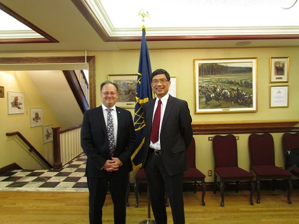 During the April luncheon, Dave Johnson (l), chapter vice president of programs, joins with guest speaker Tony Hoe, director general information management project delivery.