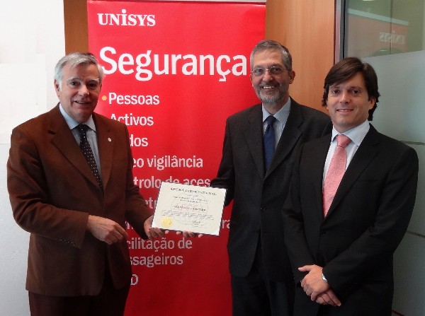 In November, Rear Adm. Carlos Rodolfo, PON (Ret.) (l), chapter president, presents Luis Deveza (c), president and chief executive officer of UNISYS Portugal, with a corporate membership certificate in the presence of Dinis Fernandes, company director.