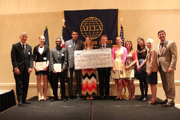 In May, local high school students receive their scholarships from Phil Platt, chapter president (far l), Paula Miller, executive director of the Pikes Peak Library District (2nd from r), and Russ Fellers, chapter vice president for education (far r).