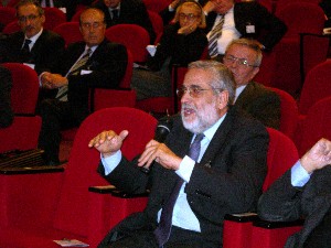 Adm. Lucio Accardo, ITN (Ret.), takes part in a debate at the chapter's December meeting before being re-elected as a member of the board of directors.