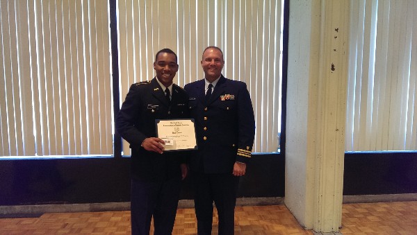 Lt. Cmdr. Steven Myers, USCG, vice president Young AFCEANs (r), presents an award to Army ROTC Cadet Jonathan T. Davis during a May ceremony.