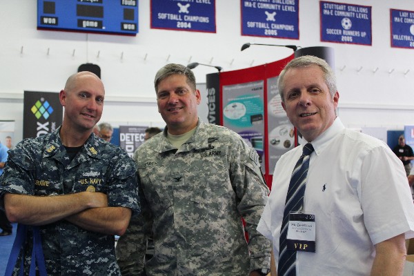 Previewing exhibits during the Summer Tech Expo VIP walk in July are (l-r) Command Master Chief Richard O'Rawe, USN, senior enlisted adviser for the Defense Information Systems Agency-Europe; Col. John Stack, USA, U.S. Army Garrison Stuttgart commander; and Roger Carpenter, chapter president.