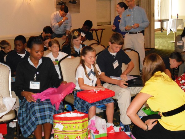 Children open up gifts at the Annual Hope Children's Home Christmas Celebration hosted by the chapter. The chapter's Young AFCEANs personally purchased the gifts, which were from each child's wish list.