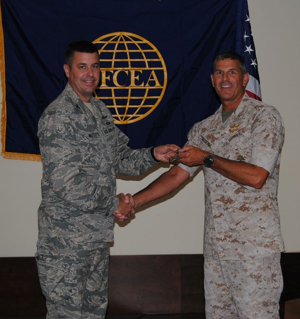 Col. Stephen Nitzschke, USMC, director of the U.S. Special Operations Command’s Innovation Lab (r), is welcomed by Chapter President Col. Michael Hill, USAF, in June.