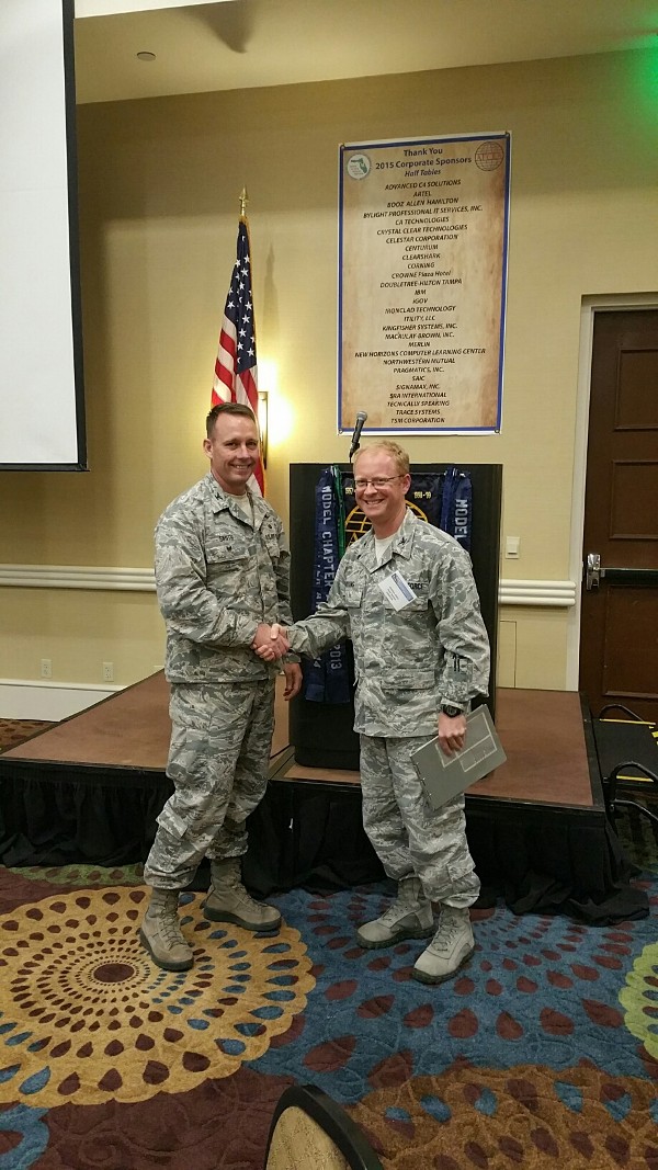 Col. Russell Smith, USAF, U.S. Special Operations Command (SOCOM) deputy J-6 and chapter president (l), thanks guest speaker Col. Matthew Atkins, USAF, chief, Intelligence Capabilities and Requirements Division (J-24), SOCOM, at the April luncheon.