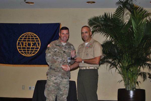 Chapter President Col. John McLaughlin, USA (l), congratulates award winner Col. Brian J. King, USMC, at an August meeting.