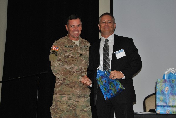 Chapter President Col. John E. McLaughlin, USA, (l) presents guest speaker Bill Burnham, technical director, USSOCOM, with a gift at the luncheon in September.