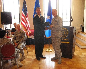 Bill Marion (l) presents Brig. Gen. Steven J. Spano, USAF, director of communications, Headquarters Air Combat Command, Langley Air Force Base, Virginia, with a token of thanks. The general served as the guest speaker for the November meeting.