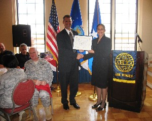 In November, Marion presents a certificate of appreciation to Denise Taylor on behalf of Booz Allen Hamilton. The company contributed to the chapter's educational fund.