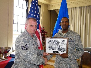 Col. A.G. Hatcher Jr., USAF (r), chapter president, presents the AFCEAN of the Month award to Technical Sgt. Paul Kodiak, USAF, 10th Intelligence Squadron, at the September meeting.