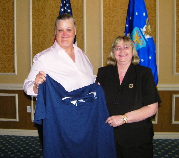 Chapter Vice President ý Industry, Melissa Errett (left), presents Ms Carpenter with a Chapter Polo ShirtTIDEWATER—Melissa Errett (l), chapter vice president, industry, presents Becky Carpenter, the July luncheon speaker, with a chapter polo shirt.
