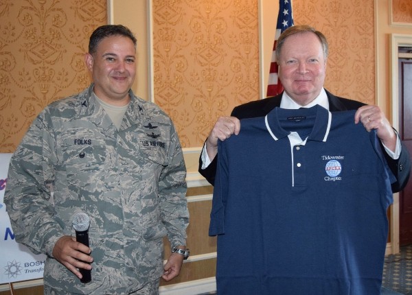 Chapter President Col. Rick Folks, USAF (l), presents Timothy L. Baker, director, Resource and Acquisition Management Office, Joint Staff J-7, a chapter polo shirt at the October luncheon.