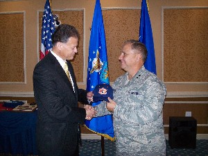 Frank Richardson (l), chapter president, presents Maj. Gen. John W. Maluda, USAF, director, Secretary of the Air Force/Cyber Transformation and Strategy, with a gift of appreciation for his April presentation.