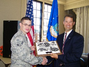 Marion (r) presents the October Airman of the Month award to Airman 1st Class Charles Sharp, USAF, from the 10th Intelligence Squadron. Airman Sharp also was selected as the chapter's Young AFCEAN of the Month.