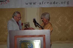 In May, Becky Nolan of AFCEA International honors Ted Bronson, chapter scholarship committee chair, for his years of dedication and service to the chapter's scholarship program.