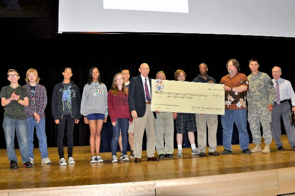 In June, Rock Schmidt (c), chapter president, presents a $1,000 chapter grant to Frank Pendzich (3rd from r) and the Wiesbaden High School RoboWarriors.