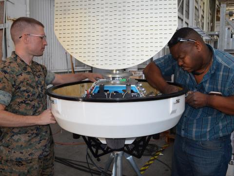  Military and civilian technical experts from Program Executive Office, Command, Control, Communications, Computers and Intelligence inspect a portable Doppler weather radar. Credit: Dawn Stankus, U.S. Navy