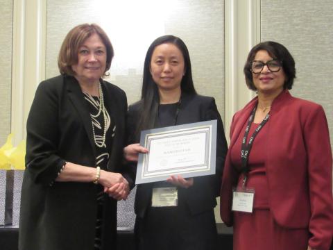 AFCEA President and CEO Lt. Gen. Susan S. Lawrence (l) and Anitha Raj (r), president of ARAR Technology, present NanoBioFab CEO Xiaonao Liu with the top award for a startup competition for emerging technologies held during AFCEA TechNet Emergence.