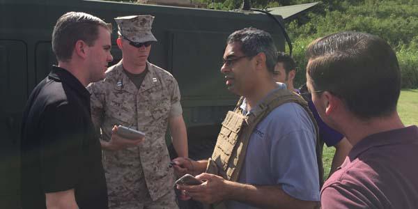 The Office of Naval Research’s Capt. Benjamin Pimentel, USMC (in uniform), discusses technical aspects of Agile Bloodhound’s demonstration architecture with industry and government partners.