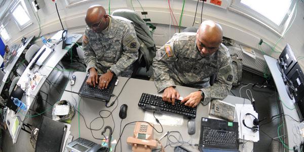 U.S. soldiers work on a Mission Event Synchronization List in the Joint Cyber Control Center during Operation Deuce Lightning in 2011.