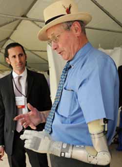 Fred Downs shows off his new prosthetic arm developed by DEKA Research and Development Corporation and funded by the Defense Advanced Research Projects Agency (DARPA). By Sandra Jontz