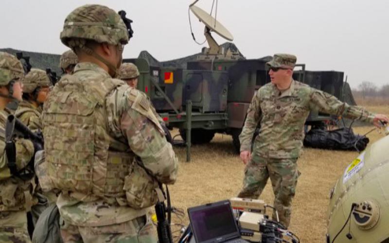 Capt. Zachary Schofield (center), USA, assistant product manager with Wideband Enterprise Satellite Systems, demonstrates an inflatable satellite antenna (ISA) to soldiers at Camp Humphreys, South Korea in 2019. The Army’s Communications Electronics Command (CECOM) has a global support program in place to ensure communications equipment readiness. Credit: Amburr Reese, CECOM Public Affairs