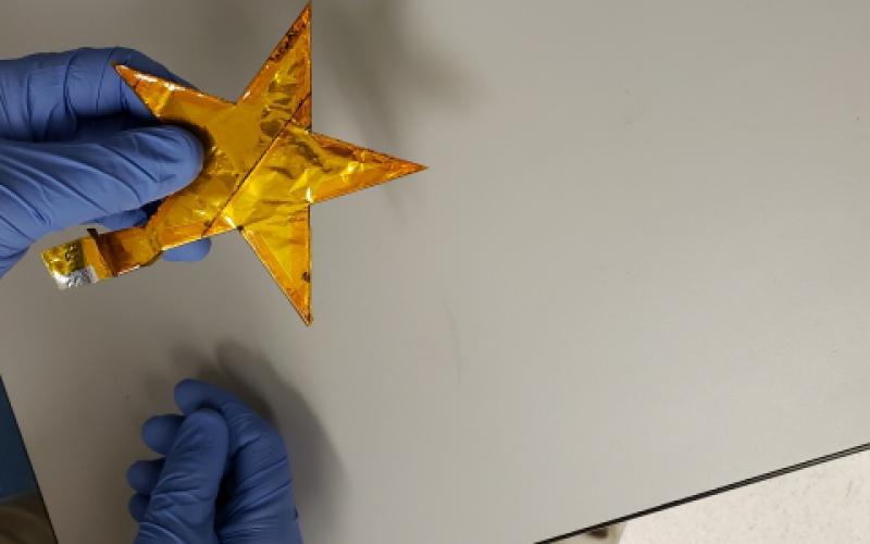 A scientist at the Army Research Laboratory (ARL) holds a demonstration battery built in the shape of an Army star. This new battery technology, constructed with a water-based electrolyte, is lightweight, flexible and safe from explosive reactions, making it more suitable for battlefield applications than conventional batteries. Army Research Laboratory photo
