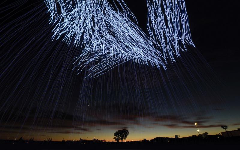 More than 500 drones illuminate the sky during a light show at Travis Air Force Base, California, July 2018. In the future, drones and an array of other machines may be easily controlled using only brain power. Air Force photo by Airman 1st Class Christian Conrad