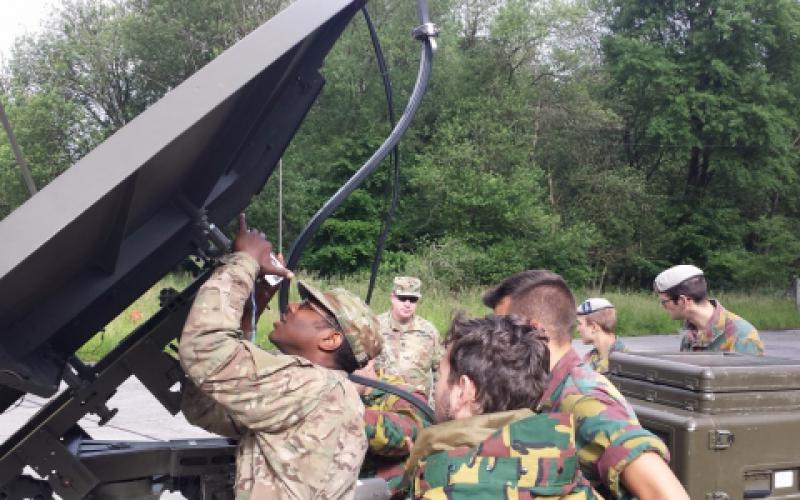U.S. soldiers from the 2nd Theater Signal Brigade and Belgian soldiers from the 6th Communication and Information Systems (CIS) Group pass voice and data through a Belgian satellite terminal during Operation Combined Lightning last June.
