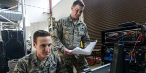 Senior Airman Thomas Goodnoe, USAF, tactical network operations technician, 1st Combat Communications Squadron (l), and Staff Sgt. Darryl Terry, USAF, cyber transport supervisor, 1st CBCS, review their systems against their technical guides during a cybersecurity audit in 2017 at Ramstein Air Base, Germany. The Air Force has added a new detachment that will provide initial training to cybersecurity airmen before they reach their mission locations. Credit: U.S. Air Force photo/Staff Sgt. Timothy Moore
