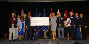 The National Math and Science Initiative presents a check for $455,217 to the schools of Richmond County, Georgia, during the AFCEA TechNet Augusta conference. Photo by Michael Carpenter