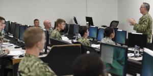 Rear Adm. Timothy White, USN, commander, Cyber National Mission Force, U.S. Cyber Command, shares feedback with students attending the Joint Cyber Analysis course at the Information Warfare Training Command (IWTC), Corry Station, Pensacola, Florida. The Unified Platform will assist members of all services in securing networks by enabling cyber warriors to prosecute full-spectrum cyberspace operations. Credit: Glenn Sircy/Center for Information Warfare Training Public Affairs