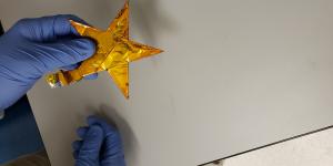 A scientist at the Army Research Laboratory (ARL) holds a demonstration battery built in the shape of an Army star. This new battery technology, constructed with a water-based electrolyte, is lightweight, flexible and safe from explosive reactions, making it more suitable for battlefield applications than conventional batteries. Army Research Laboratory photo