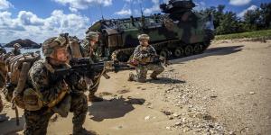 Marines exit a vehicle onto the beach during a recent amphibious landing exercise at Kin Blue Beach in Okinawa, Japan. The Marines need advanced technologies that will not limit their mobility.